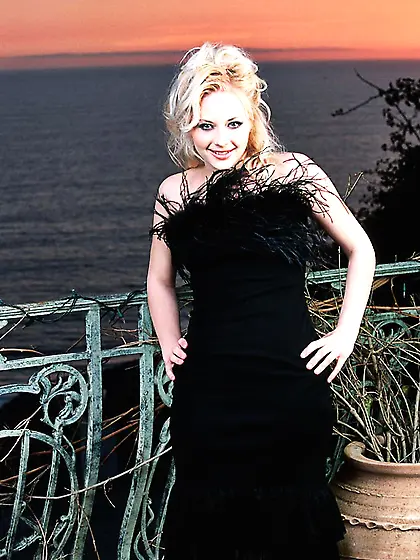 Britney Luv is in a black dress before she gets naked and squart