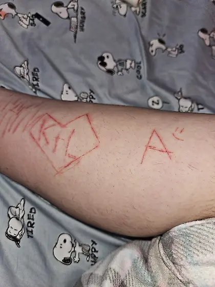 Cute 18 year old with letters craved in ankles