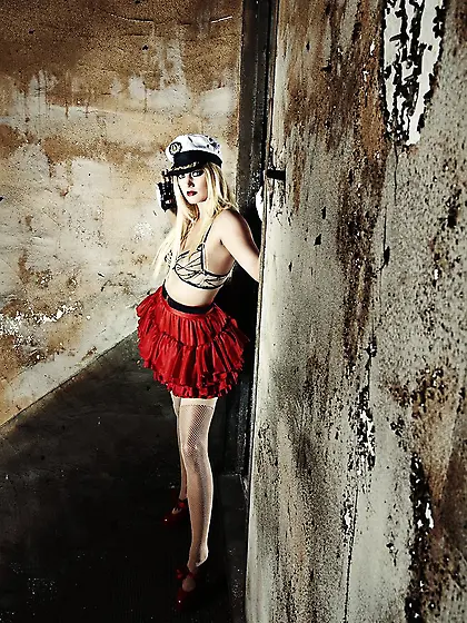 Super hot pin-up blonde model in a red skirt is eager to bare he