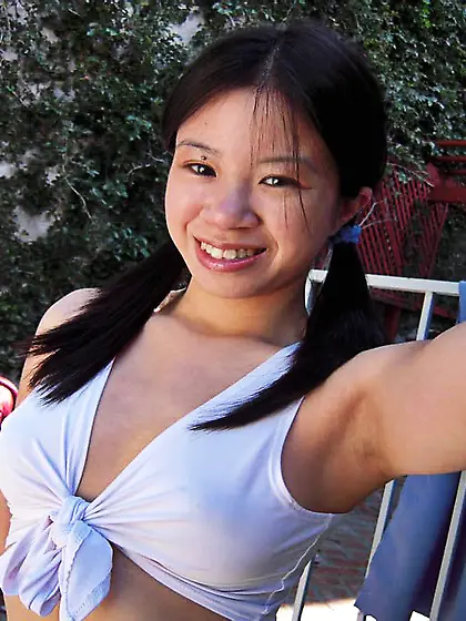 Pigtailed asian schoolgirl Asia Zo bares her assets and gives he