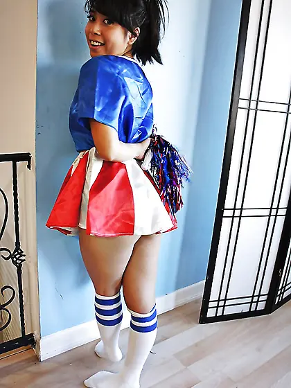 Oriental girl in cheerleader suit shows off small boobs and smoo