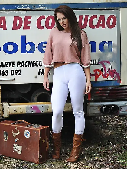 Lovely brunette model flashes bare titties while sitting on suit