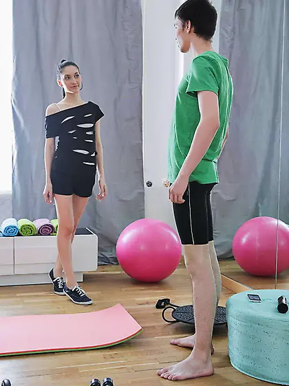 Instructor instead yoga stretches attractive brunette in cowgirl