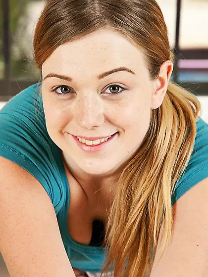 Blonde cute babe Alaina Fox is smiling in front of the camera wi