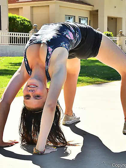 Naughty brunette doing a handstand before stripping in public