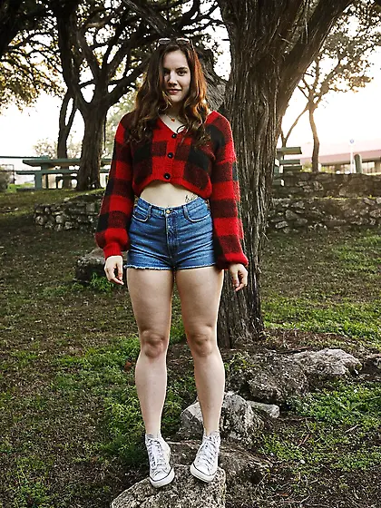 Brunette in hot pants gets naked in a forest