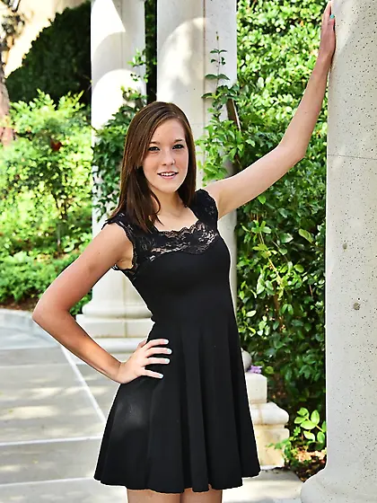 Hot teen takes off her black dress with pleasure