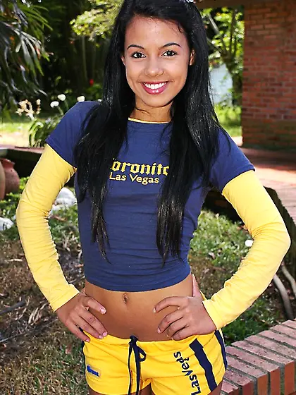 Tanned brunette hottie Gigi Spice stripping sporty shorts and pl