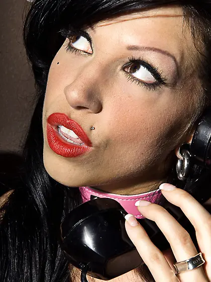 Raven-haired Roxy DeVille with pierced nipples touches her pussy