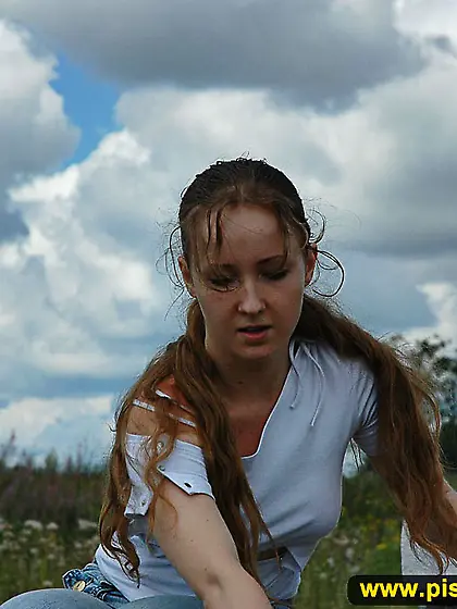 Outdoor pissing on a rock pile in summer day