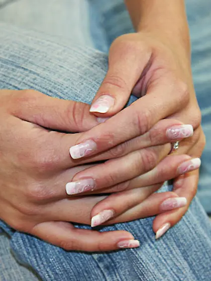 Blond-haired beauty with a great tan teasing her pussy on a bed