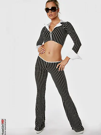 Looking naughty with a gun in her hand and white high heels,  Jan