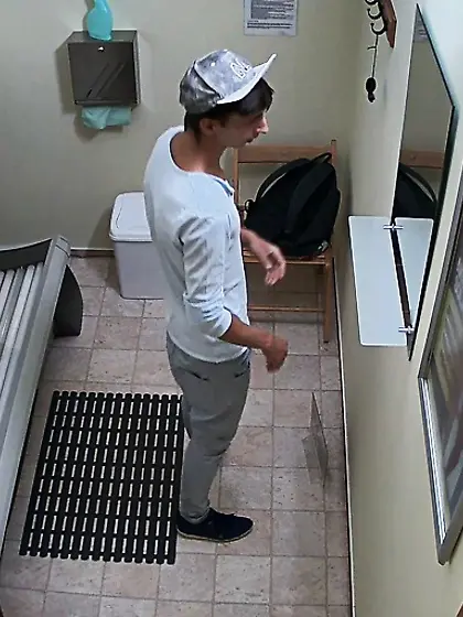 Young gay with uncut cock is tanning in solarium