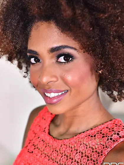 Curly-haired black babe moans while burying fingers into greedy