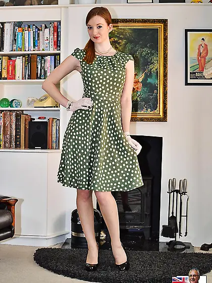 Female with red hair wears polka-dot green dress at the XXX phot