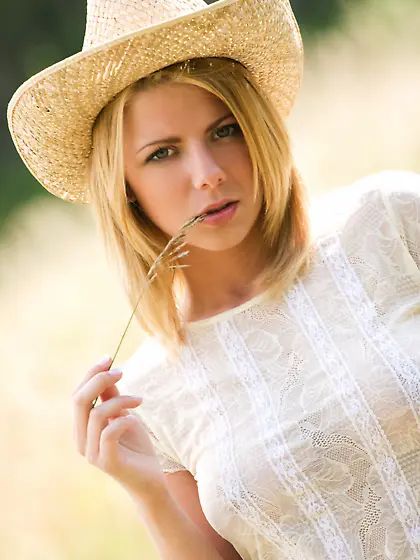 Hot blonde strips down to pose naked not far from her farm