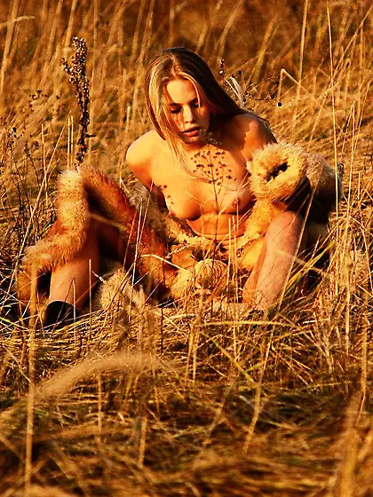 Dreamy blonde loves fur,  sunsets,  and posing naked in the fields