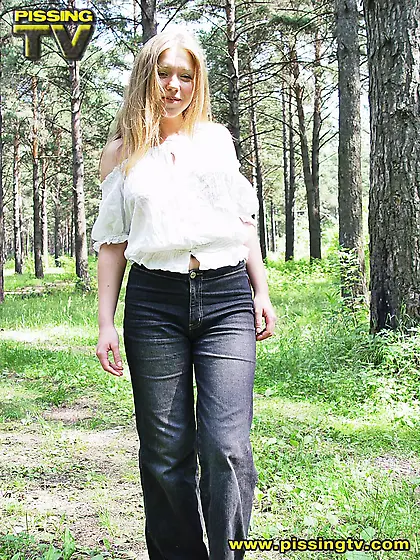Blonde pissing in the grass