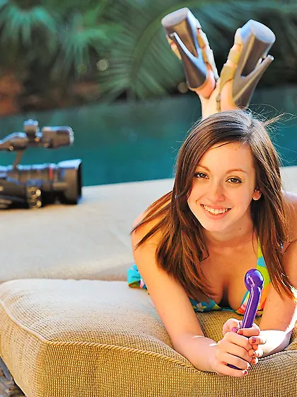 Lingerie-wearing chick shows her perfect pink pussy in a pink ro