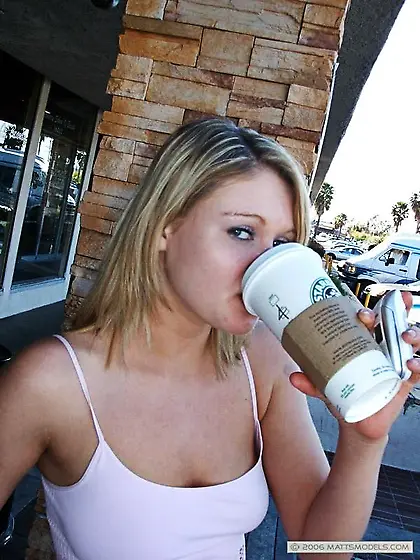 Cute faced smoking blonde Emily Evermoore poses in pink top and